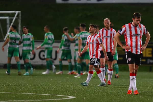 Derry City players are despondent as Shamrock Rovers celebrate a big win at Brandywell. Photographs by Kevin Moore.
