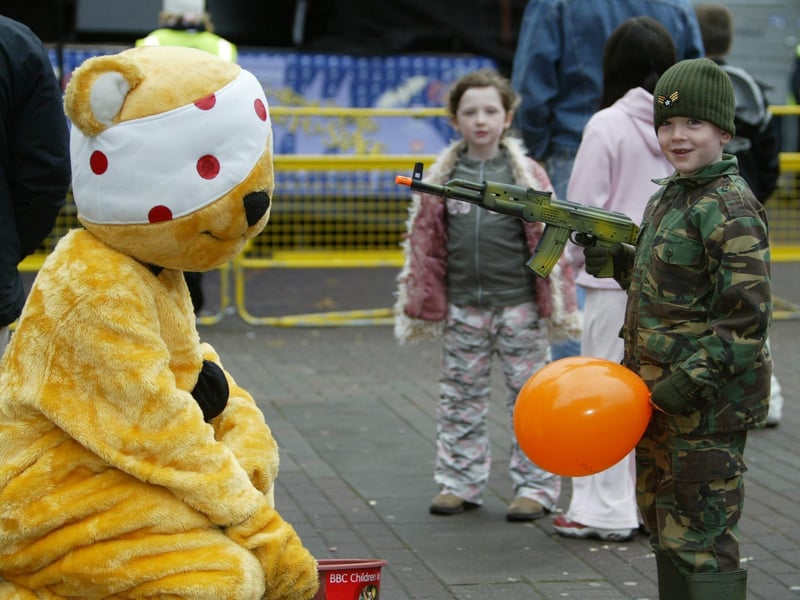 Daniel Gault holds Pudsy to ranson at the Halloween celebrations in the Guildhall Square. (031JB02):20 YEARS ON: Halloween celebrations in Derry in 2003