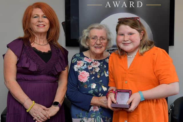 Christine McLaughlin, a pupil at Gaelscoil Eadain Mhoir, was a recipient of an Irish Language Scholarship, at the recent Donncha Mac Niallais Awards held in Dove House. Donncha’s partner Karen and his mother Mary presented the award.  Photo: George Sweeney. DER2324GS – 62