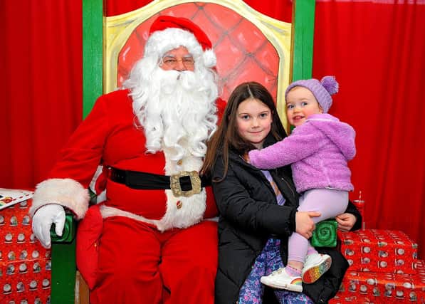 Millie and Hallie Williamson pictured with Santa at the Christmas Craft Fair held in the Galliagh Community Centre on Saturday afternoon. Photo: George Sweeney. DER2250GS – 81