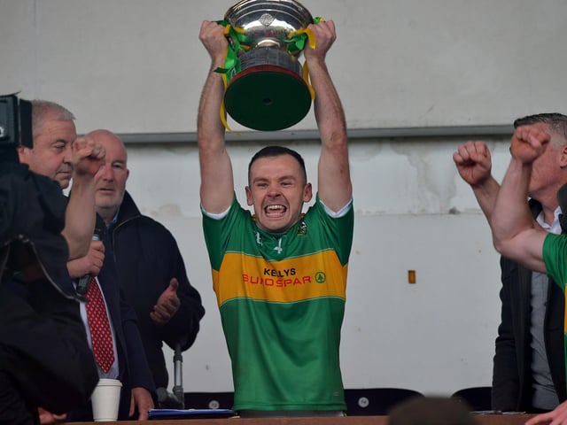 Glen captain Connor Carville lifts the Derry Senior Football Championship trophy after their win over Slaughtneil in Celtic Park on Sunday afternoon.  DER2243GS – 002