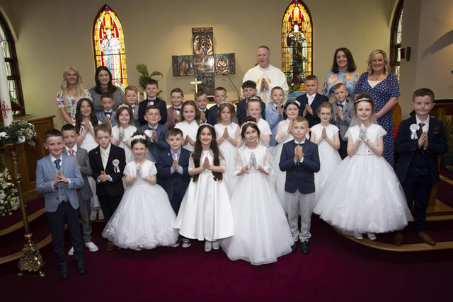 Pupils from St. Paul’s PS, Slievemore pictured after receiving the Sacrament of First Holy Communion from Fr. Sean O’Donnell at St. Joseph’s Church, Galliagh on Friday afternoon last. Inlcuded are Caitlin McGuinness, Classroom Assistant, Rachel Lynch, P4 Teacher, Roisin Logue, P4 Teacher and Catherine Green, Classroom Assistant. (Photos: Jim McCafferty Photography)