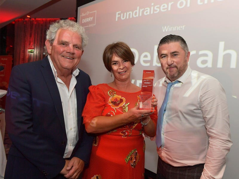 Fundraiser of the Year Award winner Deborah O’Doherty, Action Dunchene, receives her trophy from Johnny Lynch, Ward Manager, The King Bridge Foundation, on the right, and compere Adrian Logan. Photo: George Sweeney. DER2325GS – 45