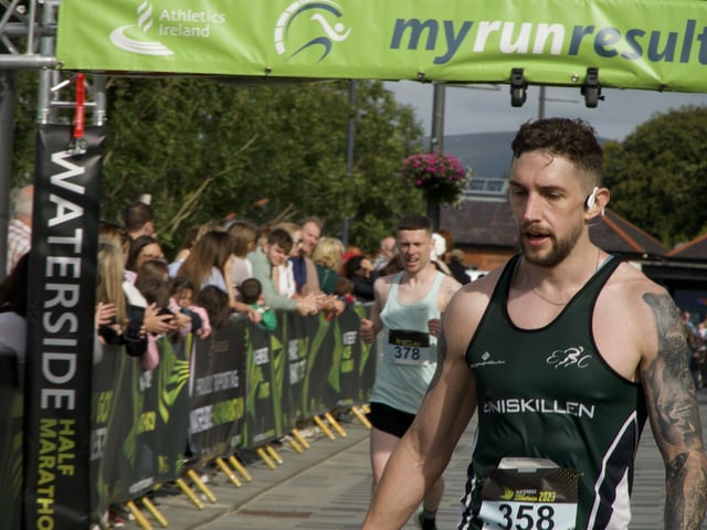 This Enniskillen athlete takes time to recover after crossing the line.