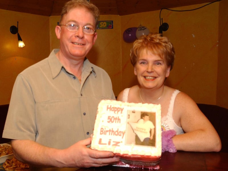 Liz McCauley, with her husband Eugene about to cut her birthday cake at her 50th birthday party in the Linen Hall bar.