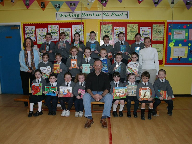 Pupils at St Paul's PS, Slievemore, winners of the school's World Book Day celebrations book review and book fair competition, receiving their prizes from storyteller Mickey Kane. Included are Katherine Gormley (left), literacy teacher and Paula Loughran (right), teacher.