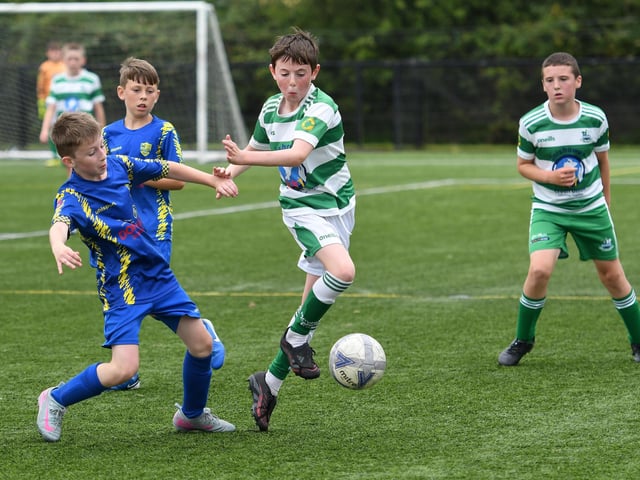 Moville Celtic's Jake McGuinness Orr hurdles this tackle from Dungannon player Jackson Maneely during their under-11's match at the Vale Centre.