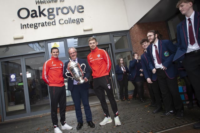 Mr. John Harkin, Acting Principal, Oakgrove Integrated College pictured welcoming Derry City players Ciaran Coll and Jamie McGonigle to the school on Thursday with the FAI Cup.