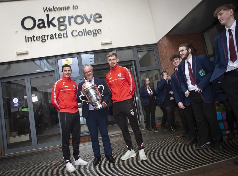Mr. John Harkin, Acting Principal, Oakgrove Integrated College pictured welcoming Derry City players Ciaran Coll and Jamie McGonigle to the school on Thursday with the FAI Cup.