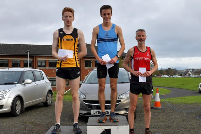 Jared Martin, Ballydrain Harriers (centre) winner of the Derry XC 6k Men’s Open race at Thornhill College. Luke Dinsmore (left), Annadale Striders, finished second and Declan Reed, of City of Derry Spartans, was placed third.  Photo: George Sweeney