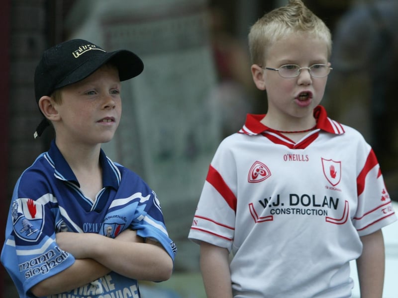 Two young boys wonder what all the fuss is about during the carnival parade. (0107JB81)