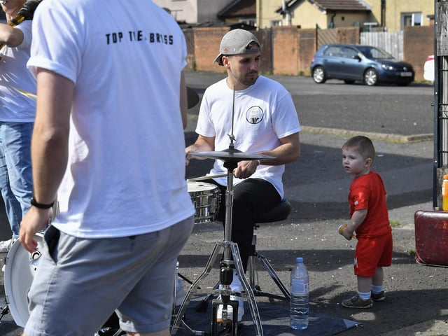 A young boy at the Top Tier Brass Band performance in Meenan Square . Photo: George Sweeney