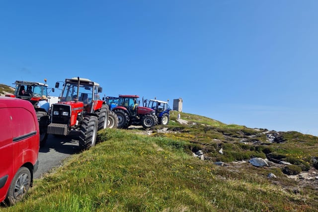 Tractors gathering under blue skies.