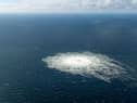 This handout picture released on September 27, 2022 by the Danish Defence Command shows the gas leak at the Nord Stream 2 gas pipeline as it is seen from the Danish Defence's F-16 rejection response off the Danish Baltic island of Bornholm, south of Dueodde. - The two Nord Stream gas pipelines linking Russia and Europe have been hit by unexplained leaks.