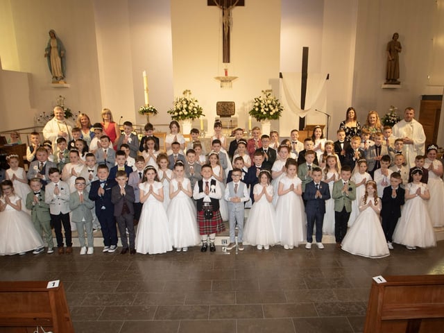 Children from St. John's Primary School who received the Sacrament of First Holy Communion from Fr. Ignacy Saniuta on Sunday last at St. Mary's Church, Creggan. Included is Fr. Daniel McFaul, Mrs. Geraldine O'Connor, Principal, Ms. Jacqueline Bradley, Mrs. Feena McGowan and Mrs. Rachel Doherty. (Photos: JIm McCafferty Photography)