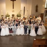 Children from St. John's Primary School who received the Sacrament of First Holy Communion from Fr. Ignacy Saniuta on Sunday last at St. Mary's Church, Creggan. Included is Fr. Daniel McFaul, Mrs. Geraldine O'Connor, Principal, Ms. Jacqueline Bradley, Mrs. Feena McGowan and Mrs. Rachel Doherty. (Photos: JIm McCafferty Photography)