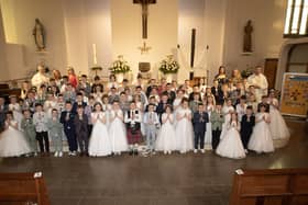 Children from St. John's Primary School who received the Sacrament of First Holy Communion from Fr. Ignacy Saniuta on Sunday last at St. Mary's Church, Creggan. Included is Fr. Daniel McFaul, Mrs. Geraldine O'Connor, Principal, Ms. Jacqueline Bradley, Mrs. Feena McGowan and Mrs. Rachel Doherty. (Photos: JIm McCafferty Photography)