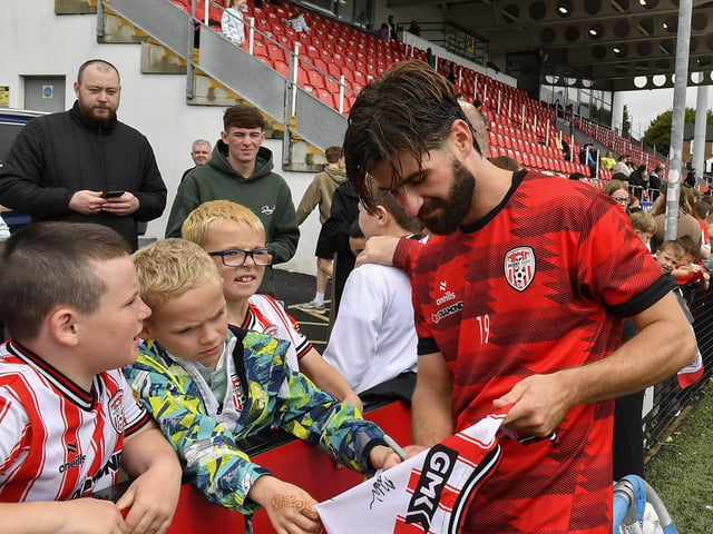 Brandon Fleming signs a shirt for a fan at the Derry City open training session on Monday morning in Brandywell Stadium. The event was organised at part of the Gasyard Feile. Photo: George Sweeney / Derry Journal