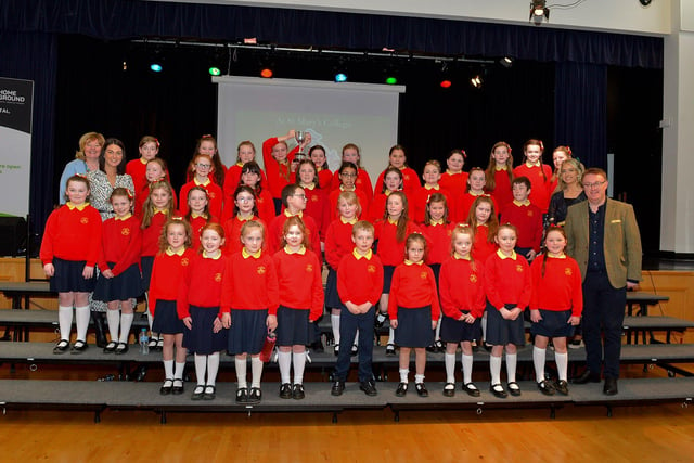 Steelstown Primary School choir, winners the Knights of Columbanus Cup and Bursary at the Derry Feis Choir Competitions held in St Mary’s College on Tuesday.  Included in the photograph is Competition Adjudicator Richard Yarr. Photo: George Sweeney.  DER2314GS – 03