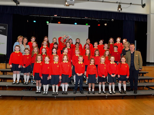 Steelstown Primary School choir, winners the Knights of Columbanus Cup and Bursary at the Derry Feis Choir Competitions held in St Mary’s College on Tuesday. Included in the photograph is Competition Adjudicator Richard Yarr. Photo: George Sweeney. DER2314GS – 03
