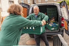Volunteers unpack food donations