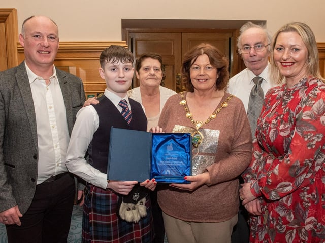 Twelve years old Jacob Laird from Bready Ulster Scots Pipe Band has been recognised by the Mayor Councillor Patricia Logue after he was crowned Ulster, All Ireland and World Champion solo snare drum champion. Pictured with Jacob are his mum and dad, Tanya and Ivor and grand parents Ann and Kenneth Scott. Picture Martin McKeown. 11.12.23