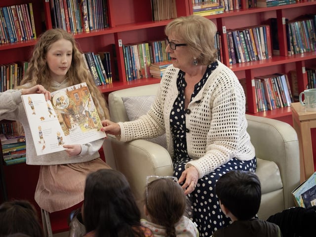 Grandparent Mrs. Evelyn O'Donnell and her granddaughter Meabh read to the pupils at Hollybush PS during World Book Day.