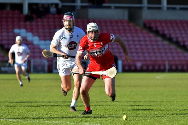 Derry’s Mark Craig and Cathal Downing of Kildare contest a loose sliothar. Photo: George Sweeney