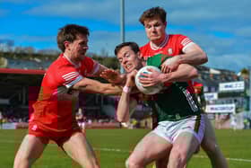 Derry's Anton Tohill and Ethan Doherty tussle for the ball with Mayo's Stephen Coen Mayo. Photo: George Sweeney