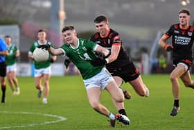 Newbridge’s Patrick McMullan gets is tackled by Clann Eireann’s Tiernan Kelly. Photo: George Sweeney