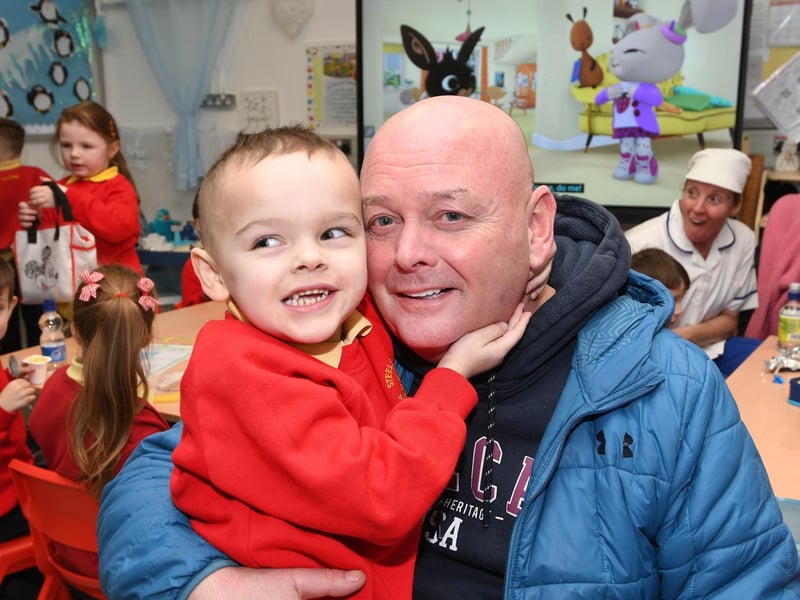 Primary 1 pupil Jordan has a big hug for grandad at Steelstown PS 'Grandparents To School Day'.