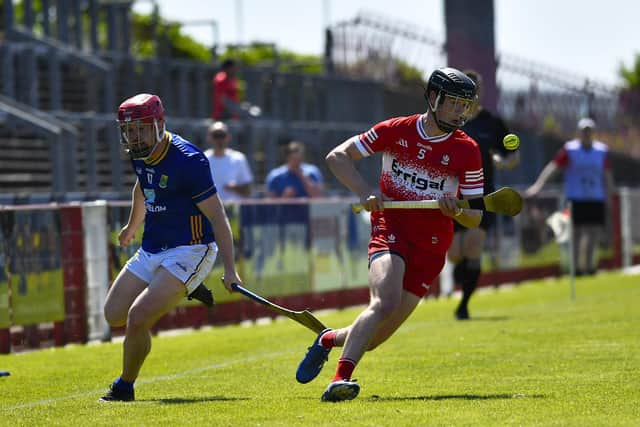 Ruairi O Mianán of Derry leaves Wicklow’s Marc Lennon in his wake. Photo:  George Sweeney