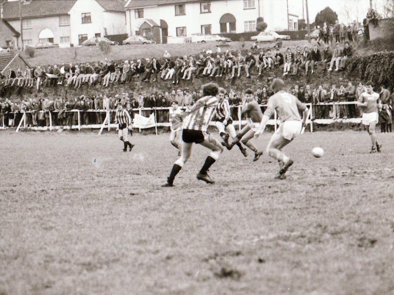 Derry City in action as fans watch on.
