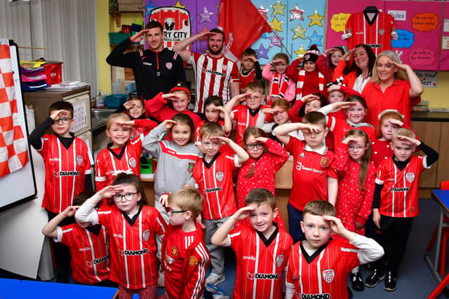 Derry City captain Patrick McEleney shows off his special celebration, which he has promised his daughter Saorlaith and her P3 classmates at Rosemount PS that he will do if he scores against Shelbourne on Sunday. Also pictured is teacher and Derry City fanatic Rory Collins.