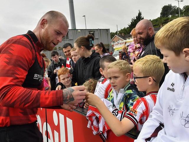 Mark Connolly signs a shirt for a fan at the Derry City open training session on Monday morning in  Brandywell Stadium. The event was organised at part of the Gasyard Feile.  Photo: George Sweeney / Derry Journal