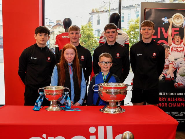 Cara O'Neill and Daithi Wickham pictured with members of Derry's All-Ireland Minor Champions team at O'Neill's Superstore last week. Photo: George Sweeney