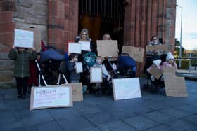 People who have been allocated new homes but have not yet got their keys protest outside the Guildhall during the meeting. (Photo: Conor McClean)