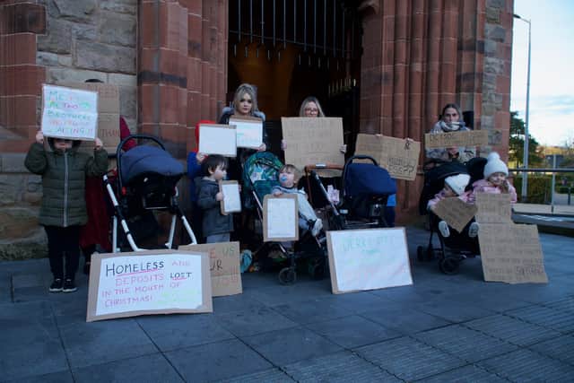 People who have been allocated new homes but have not yet got their keys protest outside the Guildhall during the meeting. (Photo: Conor McClean)