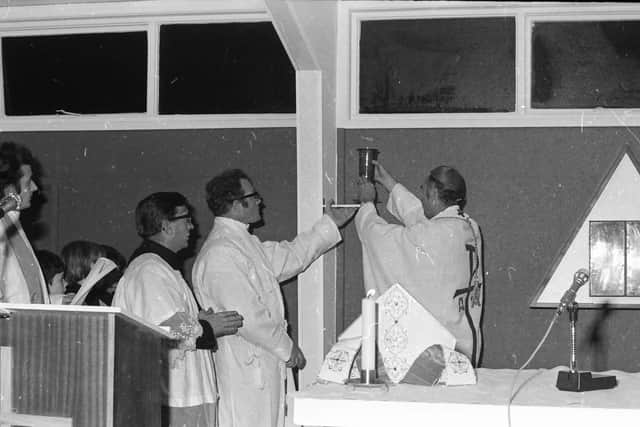 Most. Rev. Dr. Daly, Bishop of Derry, places the Sanctuary Lamp on the altar at the opening ceremony at the 'new temporary Church of St. Brigid at Carnhill, Derry'. Also in the picture are, from left, Rev. J. Farrelly, St. Columb's College, Rev. J. Clerkin, Diocesan Secretary, and Rev. Seamus O'Connell, Administrator, Carnhill.