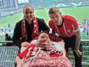 Derry superfan Darren McClelland pictured with Mark H Durkan and James McClean.