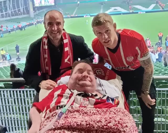 Derry superfan Darren McClelland pictured with Mark H Durkan and James McClean.