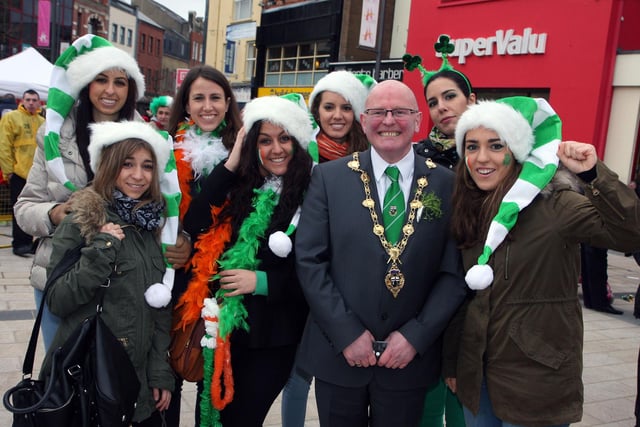The Mayor of Derry Councillor Kevin Campbell,  with a group of smiling girls from Spain, on his tour of Waterloo Place during the St. Patrick’s Day celebrations on Sunday.