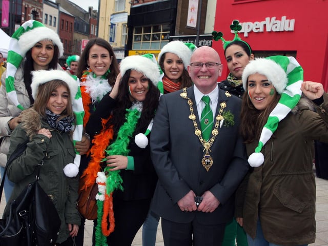The Mayor of Derry Councillor Kevin Campbell, with a group of smiling girls from Spain, on his tour of Waterloo Place during the St. Patrick’s Day celebrations on Sunday.