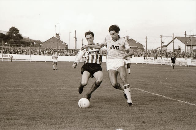 Paul Curran gets in a tackle on Alan Smith.