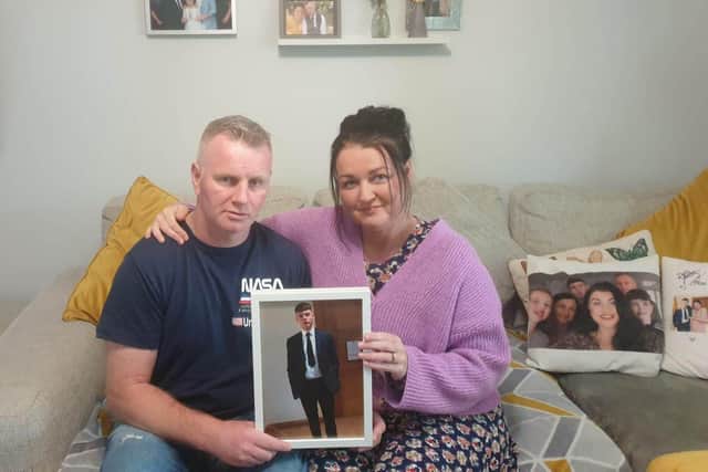 Tony and Sabrina Edgar with a picture of their son Jack.