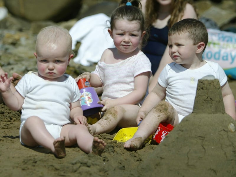 Waterbabies......... 1 year old Conal and Jake Harkin and 2 year old Molly McDaid muck about in the sand at Neds Point yesterday. (0508JB74):Derry youngsters enjoying summer in August 2003