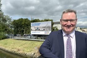 Jonathan McKeown (CEO of CRASH Services) proudly beside one of the new Derry-Londonderry billboards