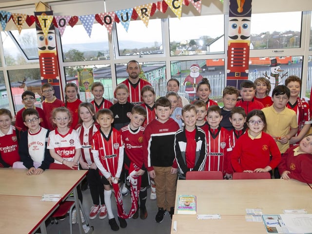 Patrick and Shane McEleney bring the FAI Cup to Mrs McGlinchey and Mr O'Donnell's P6. (Photo: Jim McCafferty)