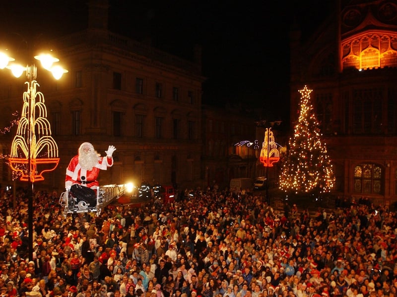 SANTA SURFING - Santa delivering treats to the large crowd in the Guildhall on Wednesday night for the Christmas lights switch on. (1911C) : Christmas Lights Switch on, from November 2004 in the Guildhall Square.