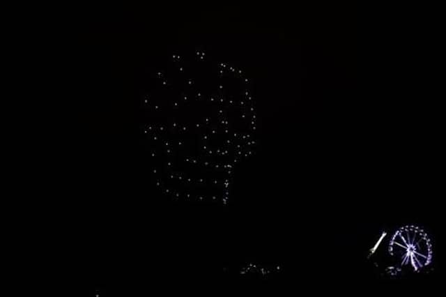 The ginat skull taking form over the River Foyle, dwarfing the big wheel at Ebrington.